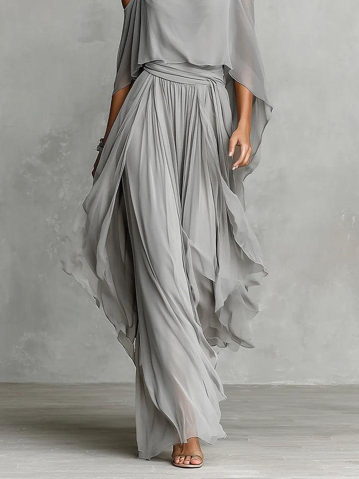 Set in gray chiffon with a fluid tank top and off-the-shoulder pants
